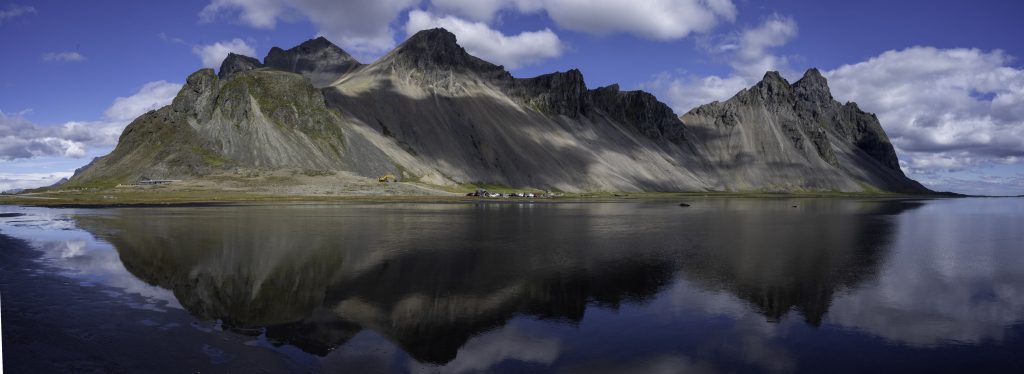 Vestrahorn, Iceland. This gabbro rock pinnacle of land stands out among black sand dunes, black sand beaches, and a magnificent reflecting lagoon